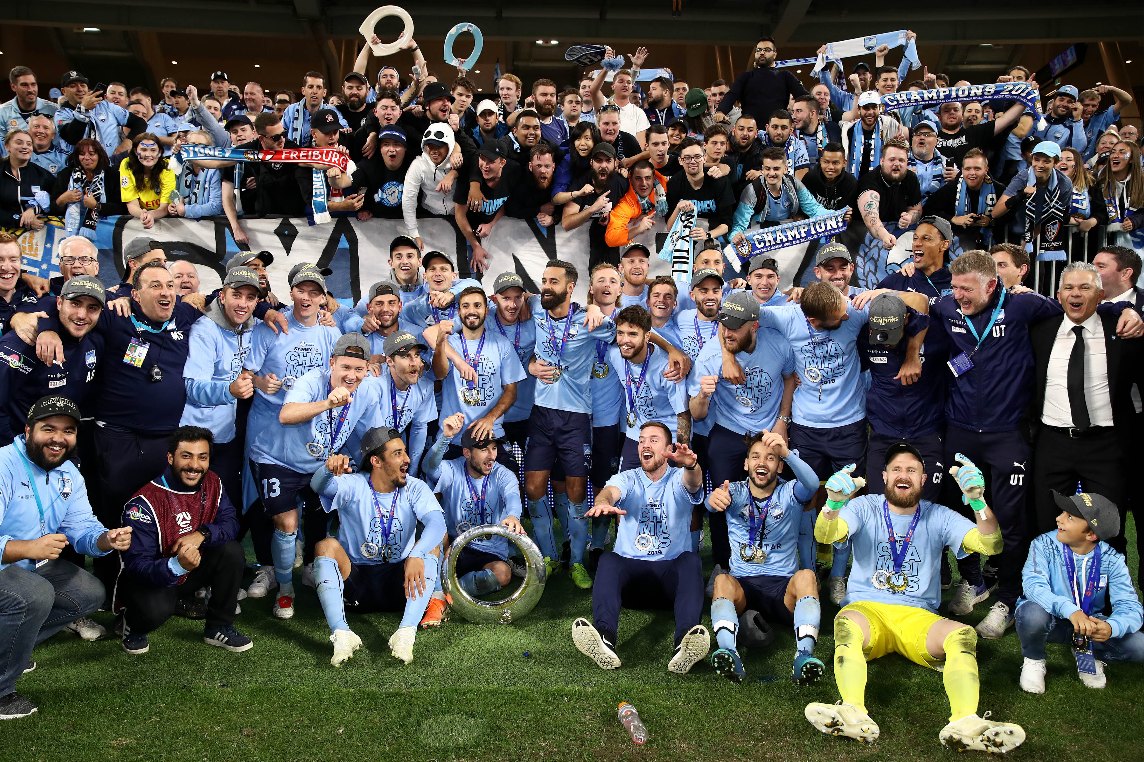 Sydney FC players pose for a snap in front of the travelling fans