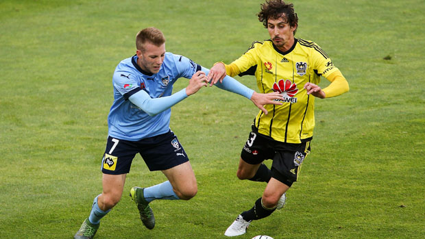 Andrew Hoole fights for the ball with Phoenix midfielder Albert Riera.