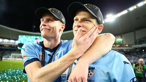 Alex Wilkinson and Matt Simon celebrate following Sydney FC's Grand Final triumph over Melbourne Victory.