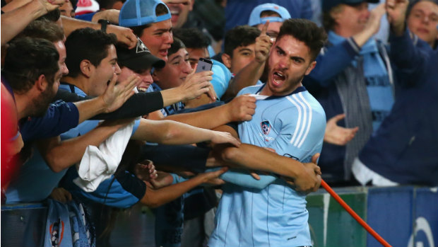 Chris Naumoff celebrates Sydney FC's fourth goal with the fans.